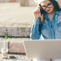Arkane Self-Publishing Woman Outside Working on Computer