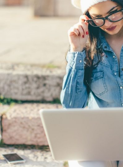 Arkane Self-Publishing Woman Outside Working on Computer